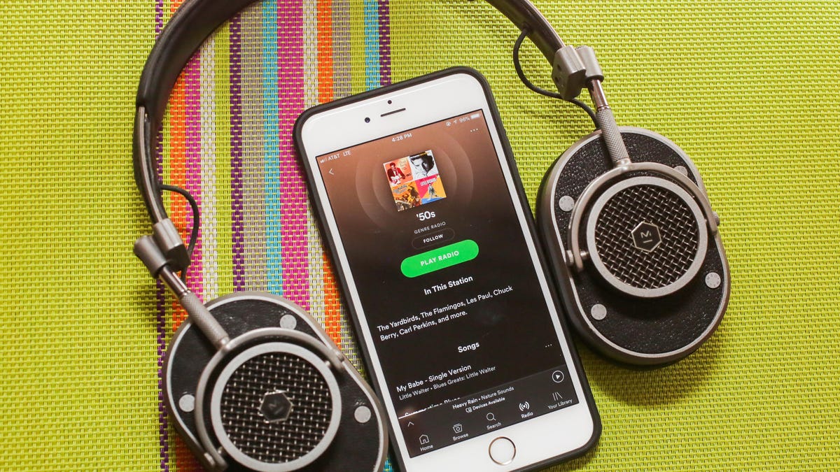 spotify app on a phone and a headphone