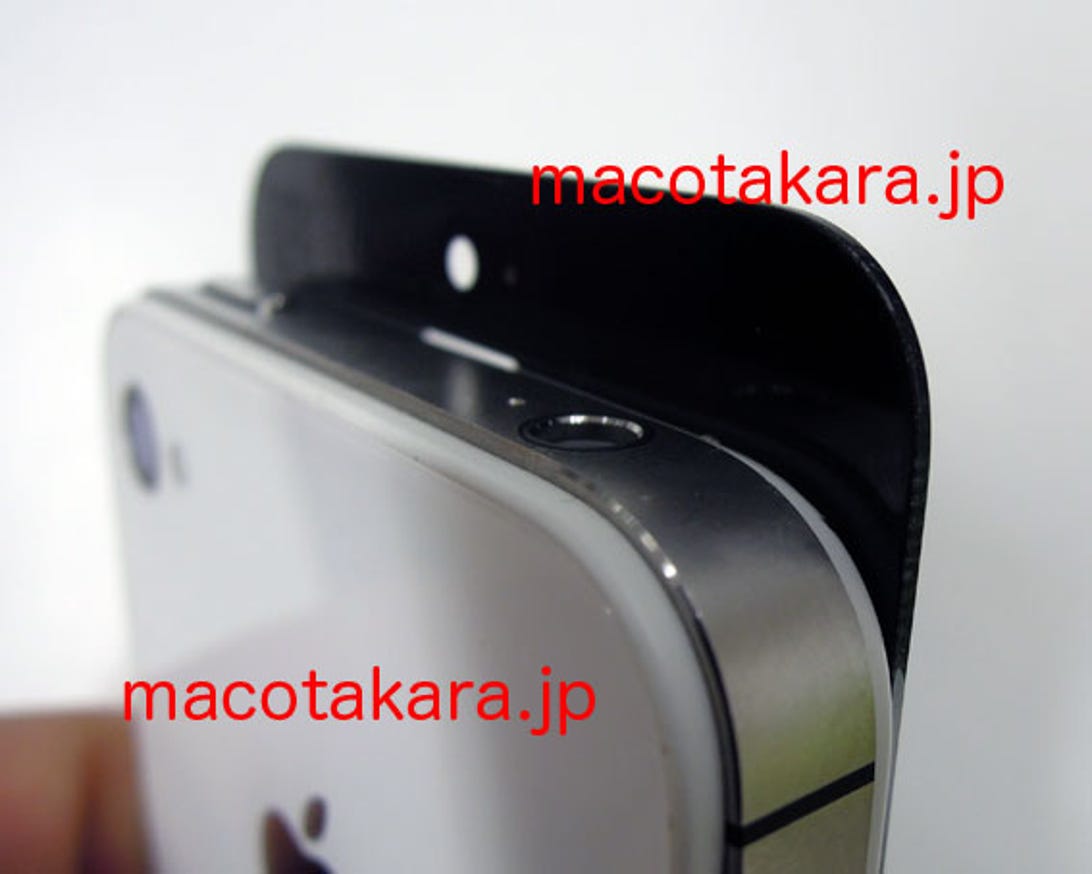 An iPhone 4S next to the purported screen part.