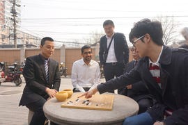 Go champ Ke Jie at Go board with Google CEO Sundar Pichai.