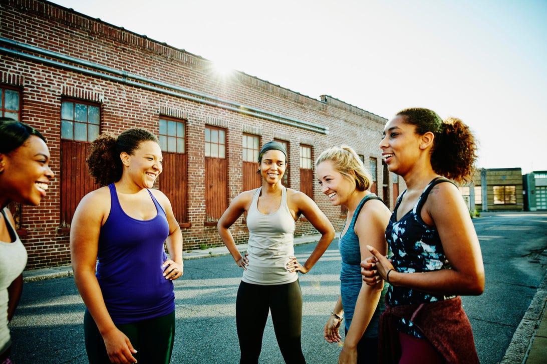 fitness community young women laughing after a workout outside