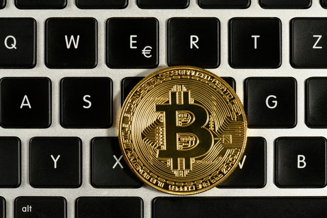 Symbol image digital currency, gold physical coin bitcoin on keyboard