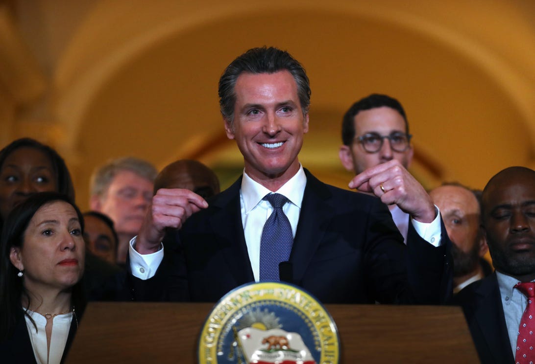 California Gov. Gavin Newsom speaks from behind a podium at a news conference in Sacramento in March.