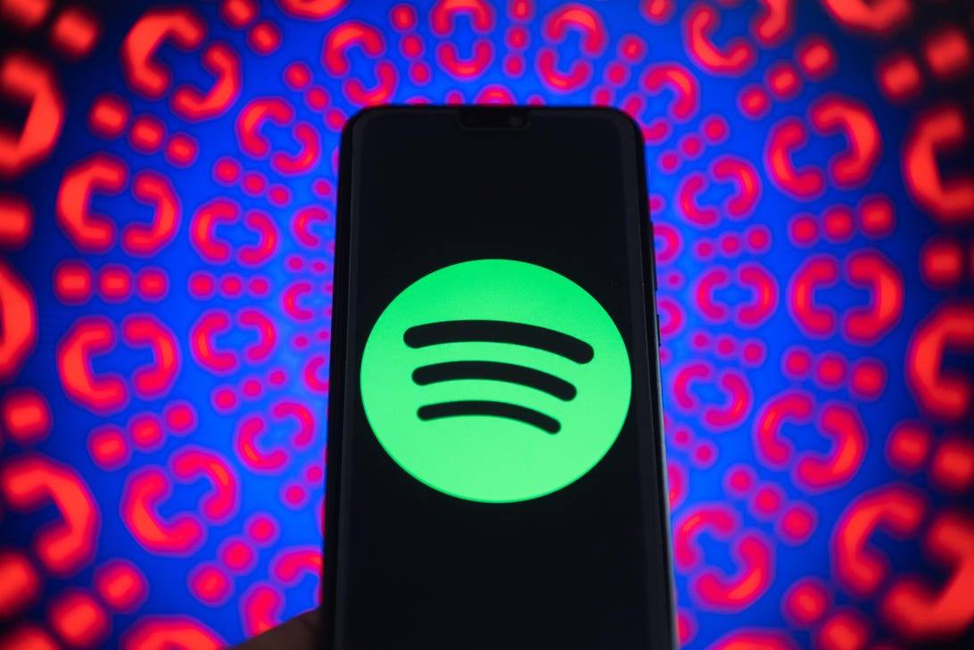 Spotify logo is seen on a mobile phone