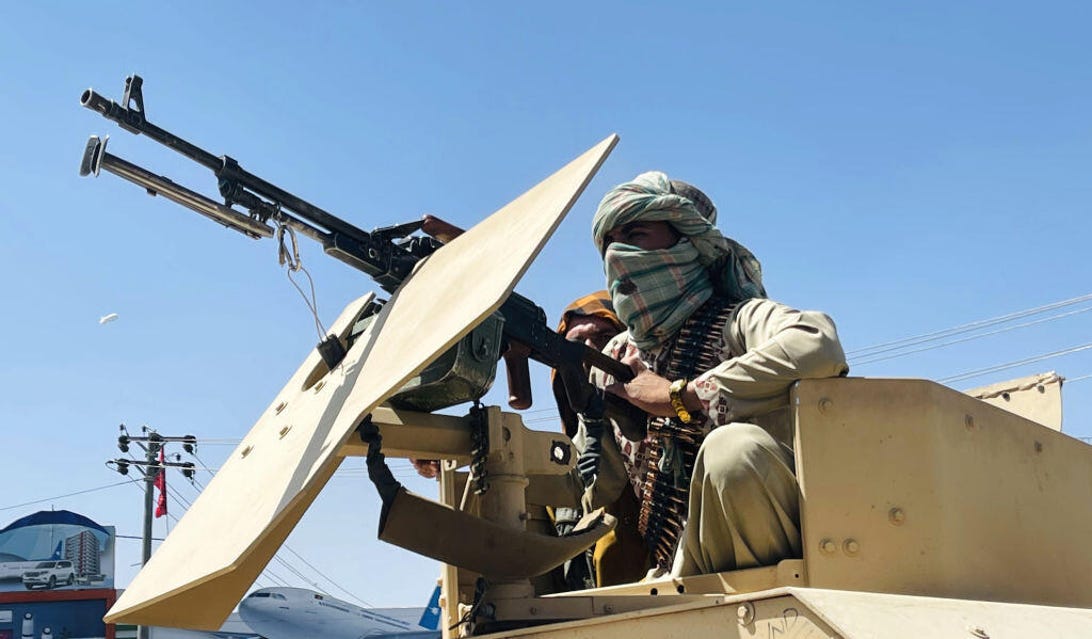 Taliban fighter with a vehicle-mounted machine gun