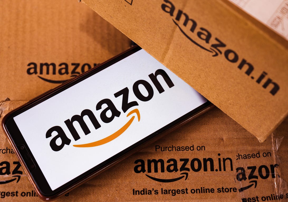 A phone with the Amazon log sits among Amazon boxes