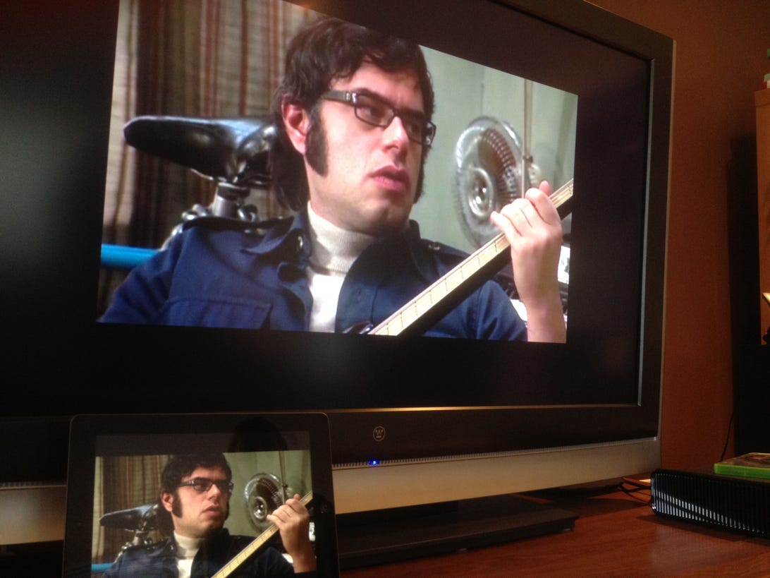 "Flight of the Conchords" shown via a new iPad connected to an Apple TV and running the Comcast Xfinity TV app.