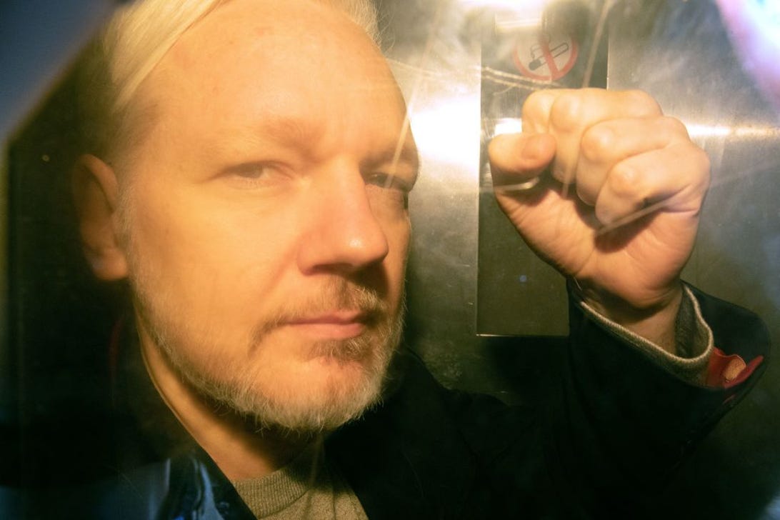 Julian Assange with raised fist