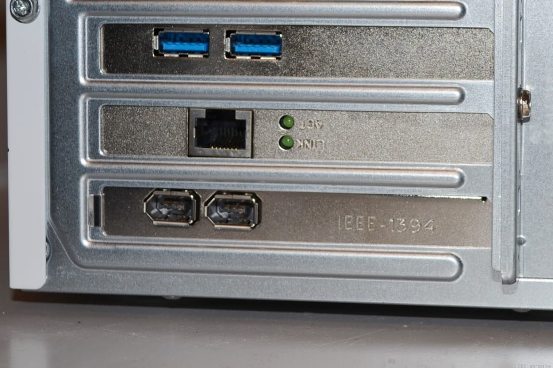Two USB 3.0 ports (note the color blue) and two FireWire 400 ports (bottom) on the back of a desktop computer.