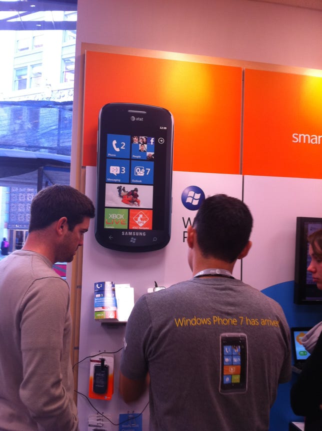 Customers at an AT&T retail store in San Francisco get a hands-on demo with two Windows Phone 7 launch devices.