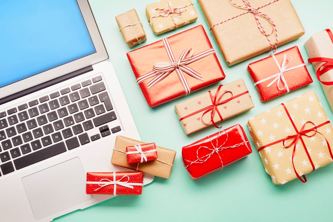 Gift-wrapped boxes next to a laptop