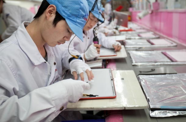 A photo of a factory worker taken from Apple's annual report.