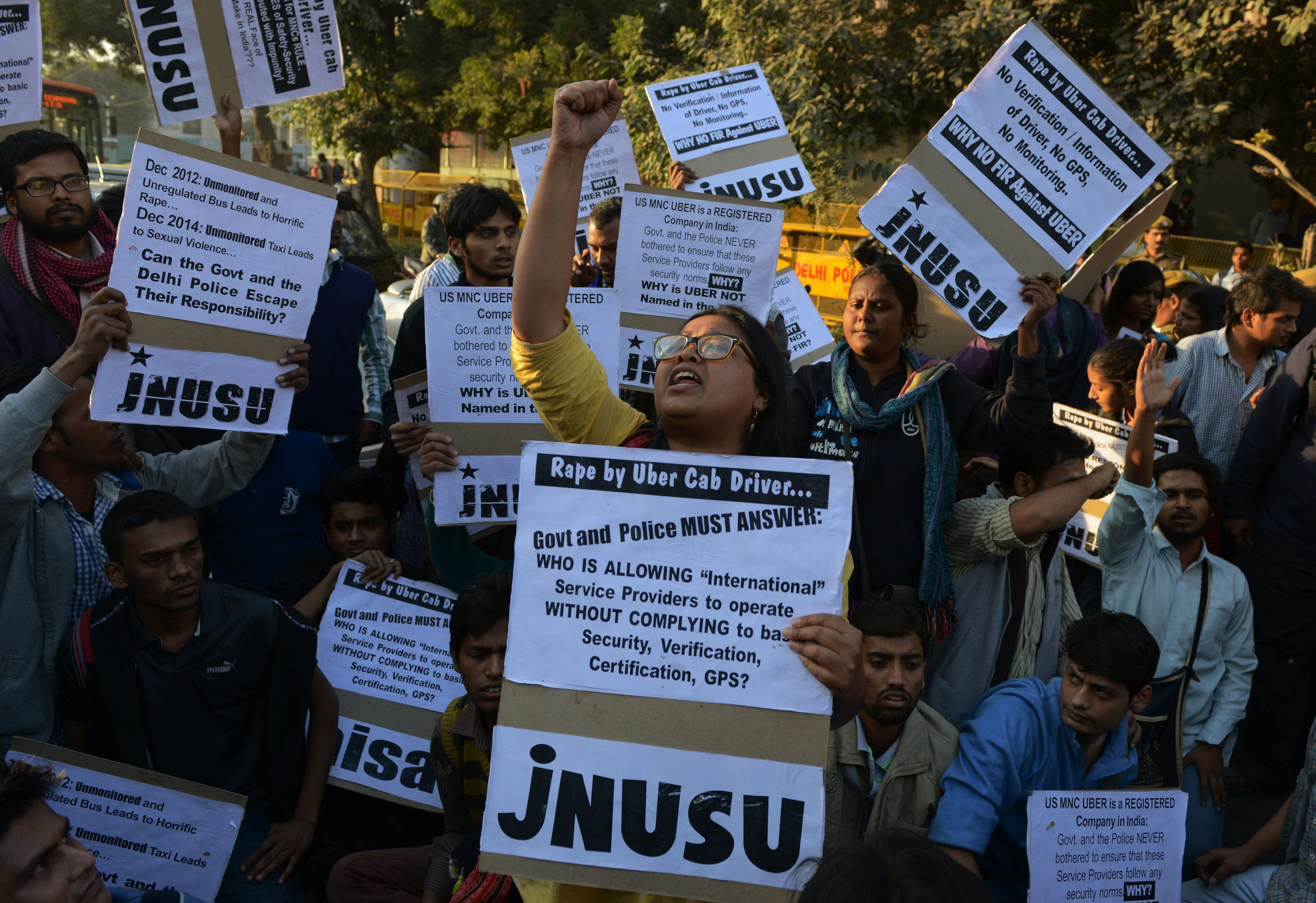 Uber says it's taking steps to increase the safety of its passengers. Above: Indian residents take part in a protest last December over the alleged rape of a passenger by an Uber driver in New Delhi.