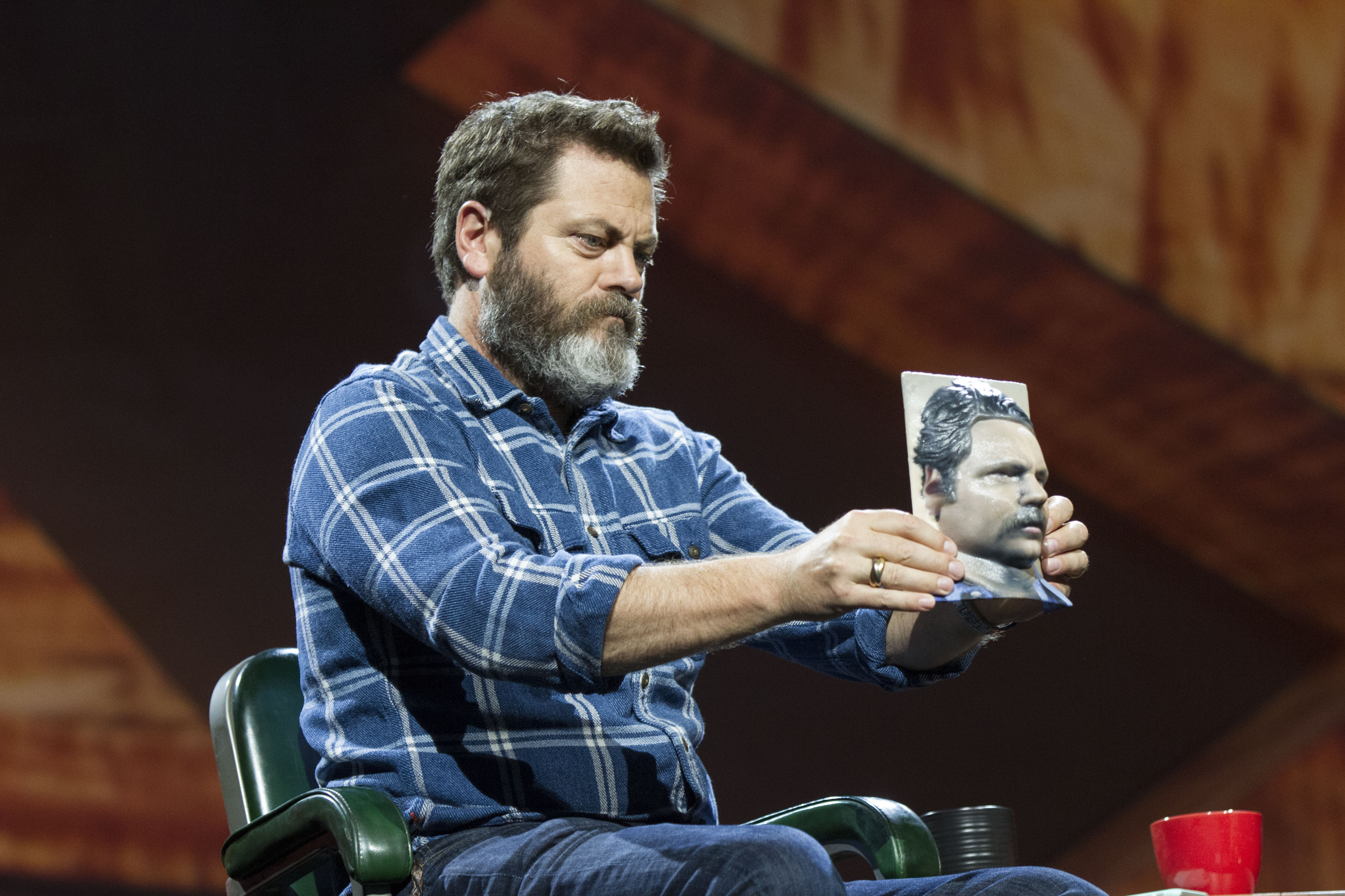 At Adobe's Max conference, Parks and Recreation actor Nick Offerman holds a 3D-printed model of his head reconstructed from a photo.