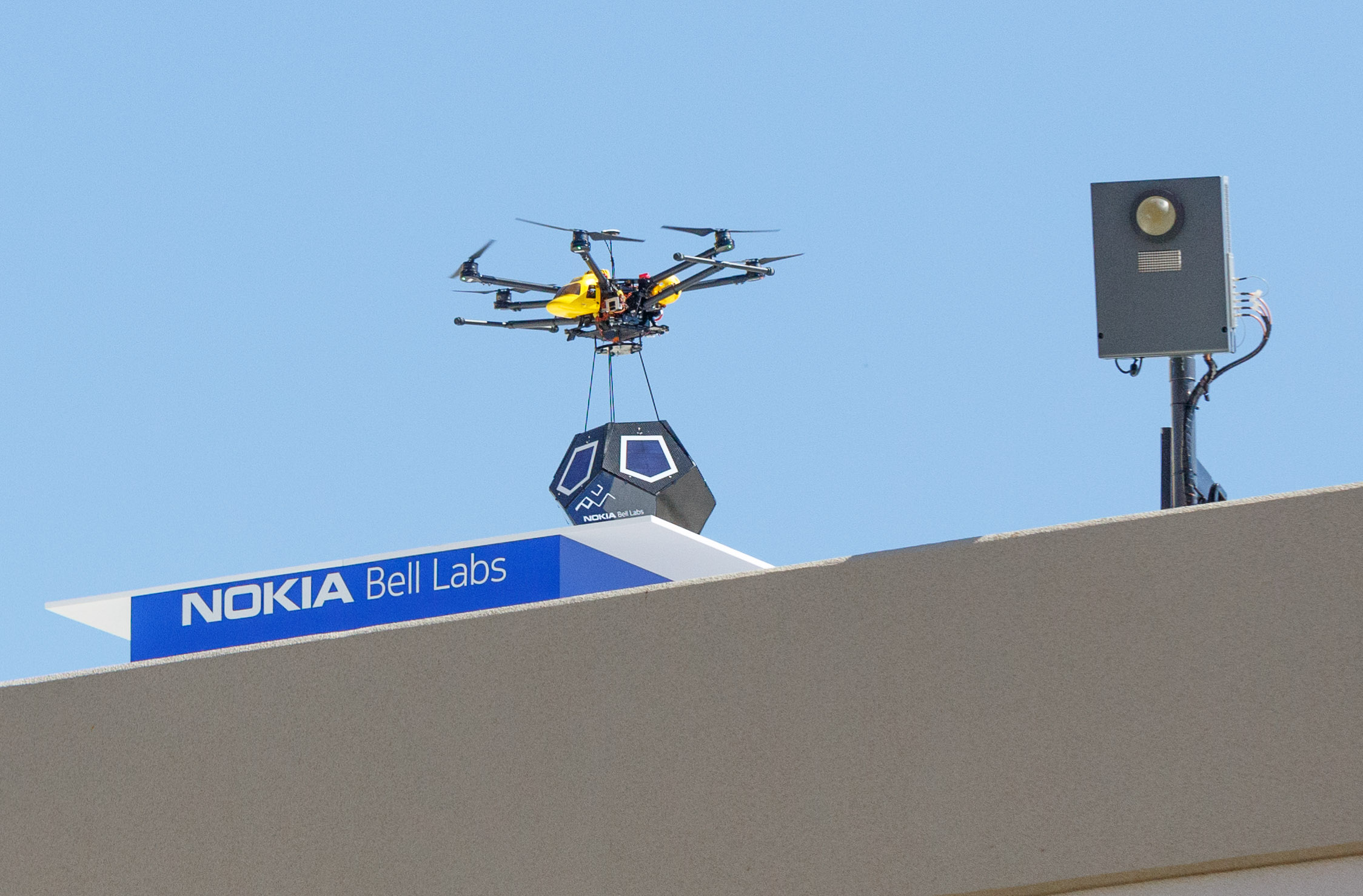 A drone lands portableA drone lands a portable, solar-powered, short-range high-speed network unit called a Future Cell on a roof near Nokia Bell Labs in Sunnyvale, California., solar-powered, short-range high-speed network unit called a Future Cell on a roof near Nokia Bell Labs in Sunnyvale, California.