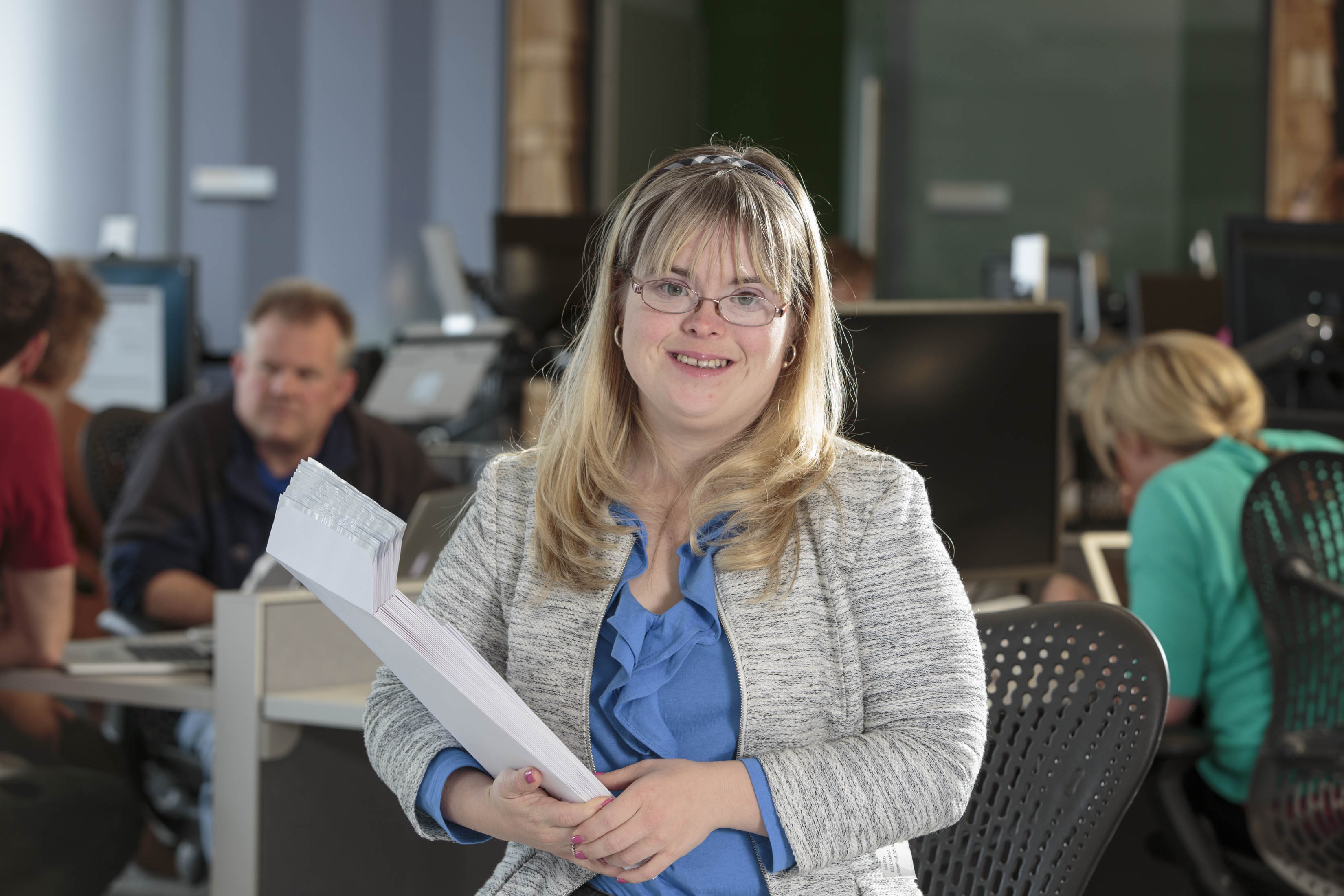 Kate Bartlett, who has Down syndrome, has been working as a benefits assistant at Aquent for 11 years, where she uses technology skills to do her job.