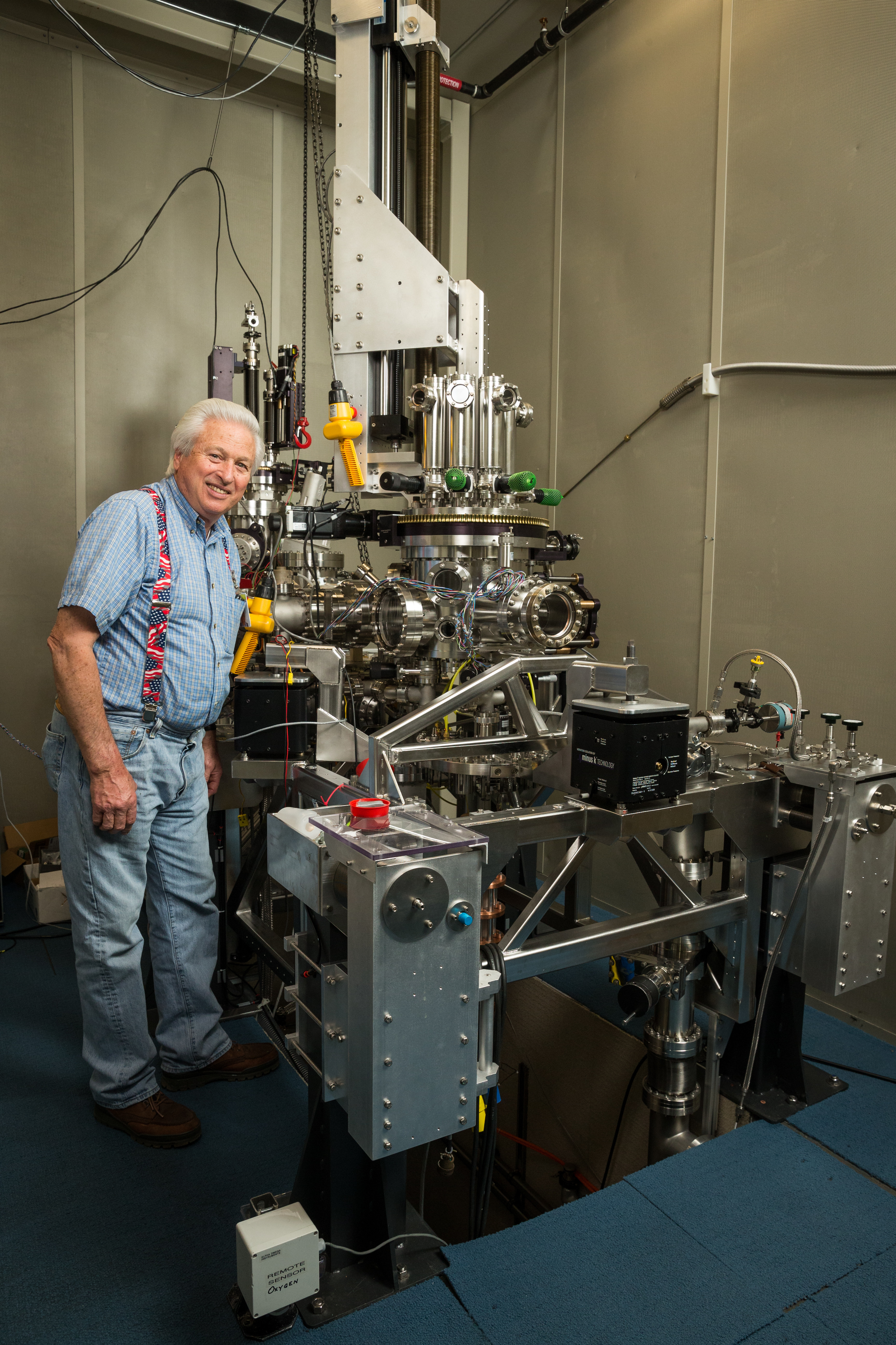 IBM can store a bit of data on a single atom, but the scanning tunneling microscope needed to do so is vastly larger. Here IBM microscope mechanic Bruce Melior stands by the device.