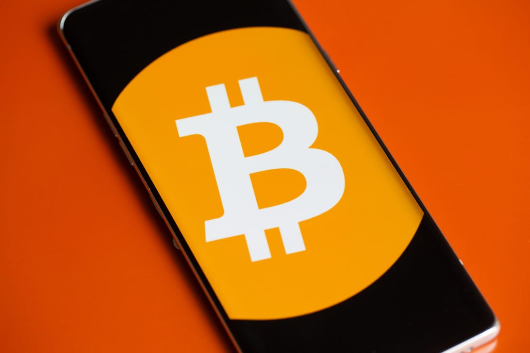 Bitcoin logo on a phone screen.