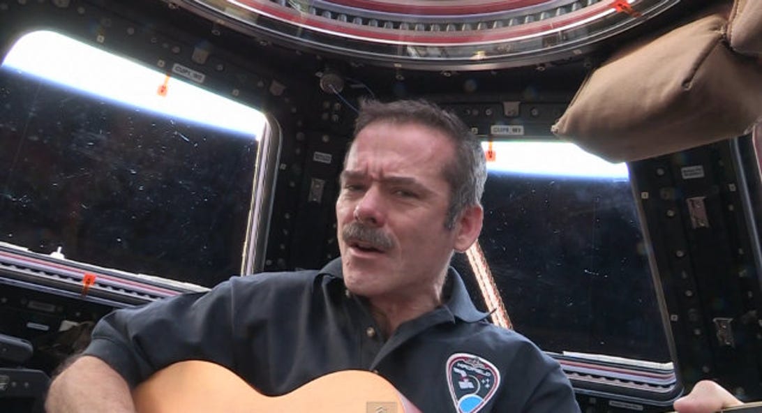 Chris Hadfield with guitar in space