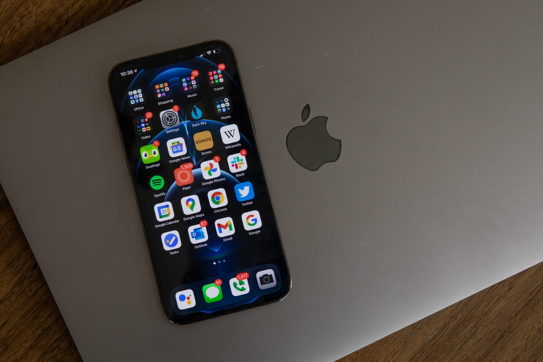 iPhone 12 Pro Max with MacBook Pro and Apple logo