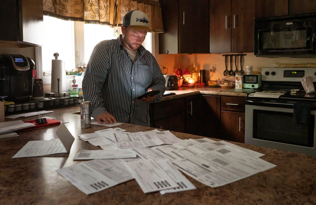 Central Maine power customer reads information on his phone about upcoming public hearings by the Maine Public Utilities Commission regarding billing and customer service issues of Central Maine Power while in the kitchen of his Winthrop home on Tuesday, June 11, 2019.