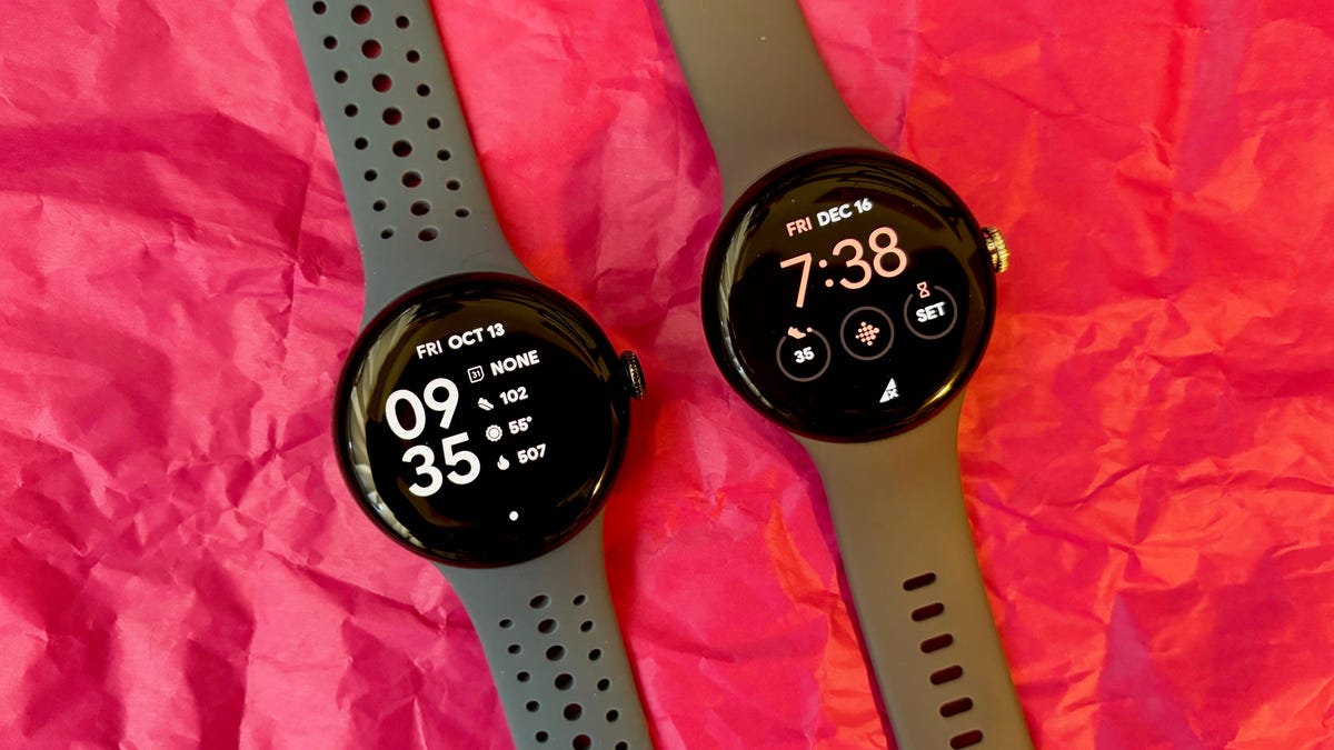 The Pixel Watch 2 (left) next to the Pixel Watch on a pink background