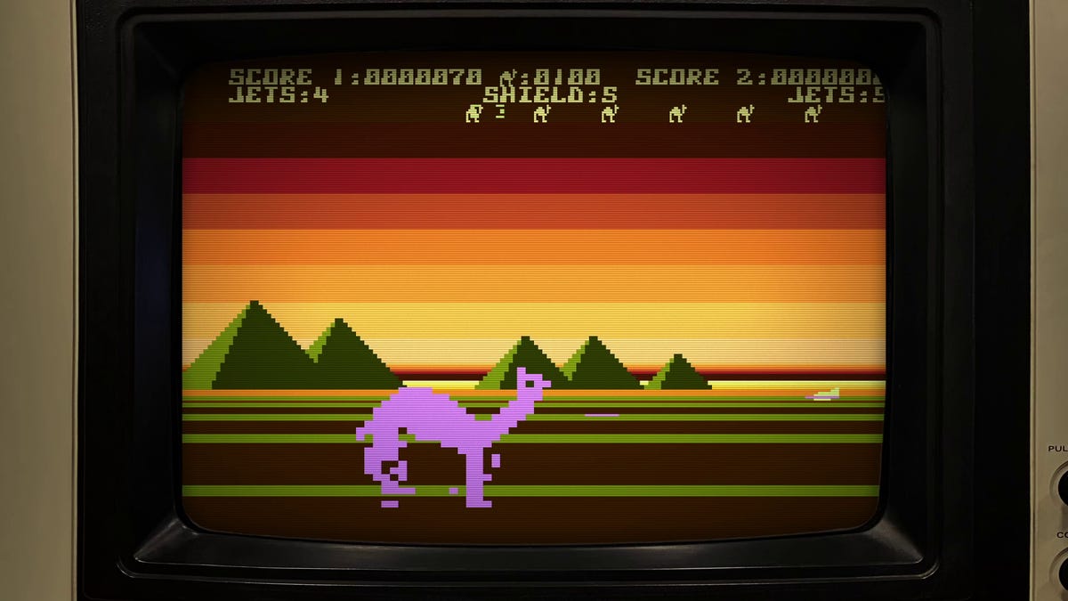 A spaceship firing at a giant camel in an old video game