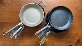 six nonstick pans on wooden table