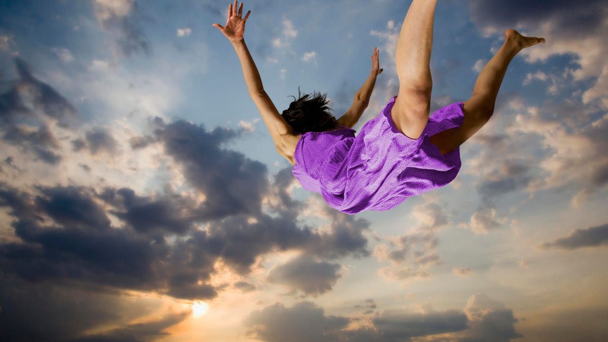 girl in purple dress falling through the sky