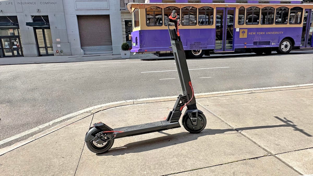 The Turboant V8 electric scooter standing on a sidewalk in New York City.