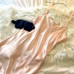 A pink nightgown from Fishers Finery on top of a fluffy blanket
