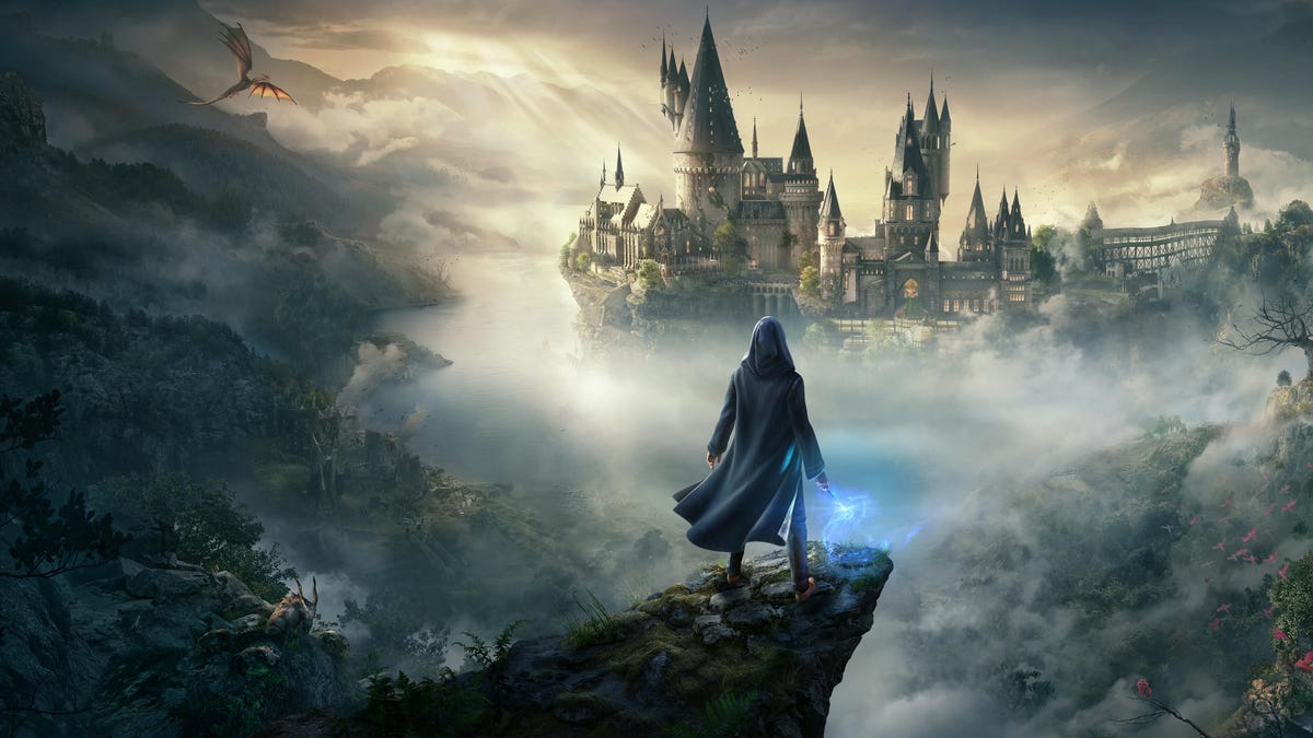 a wizard brandishes a wand on a rocky outcrop overlooking Hogwarts