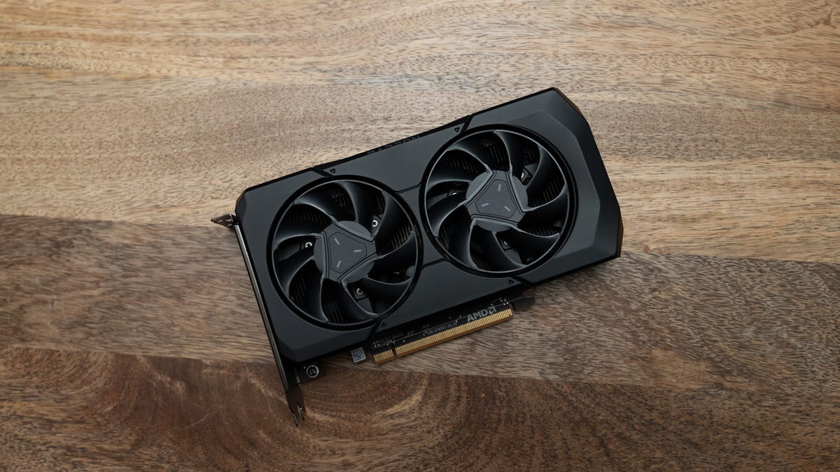 Radeon RX 7600 fans side up, slightly tilted and lying on a wood surface