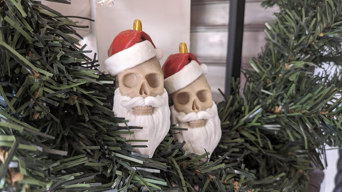 2 3D printed skulls with santa hats and beards