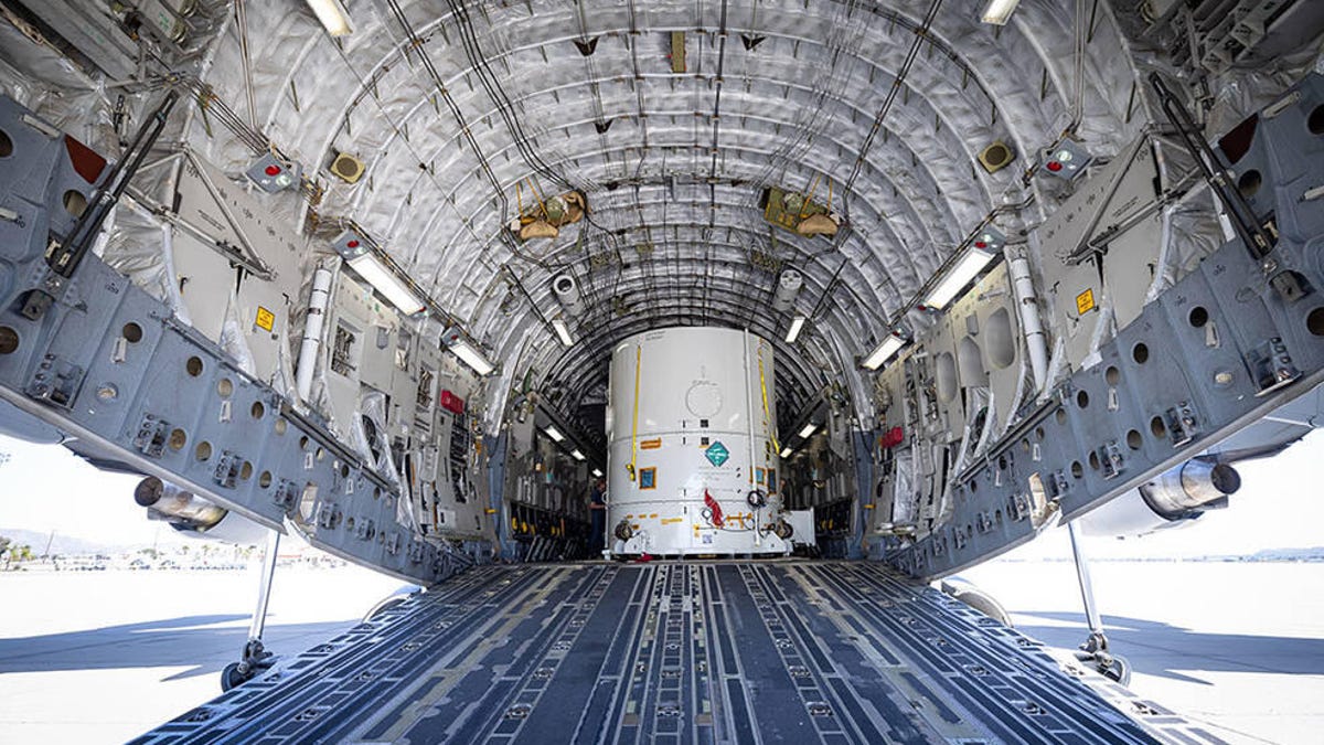 NASA's Europa Clipper in its shipping container aboard a cargo plane.