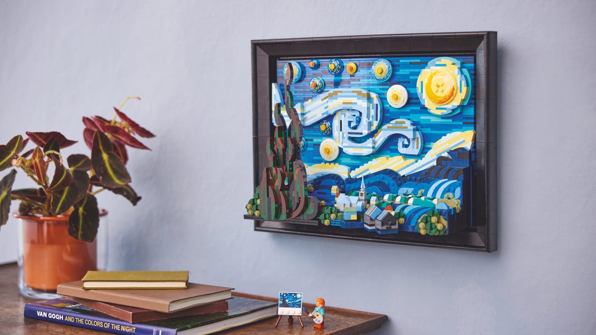 lego starry night hangs on the wall above a desk