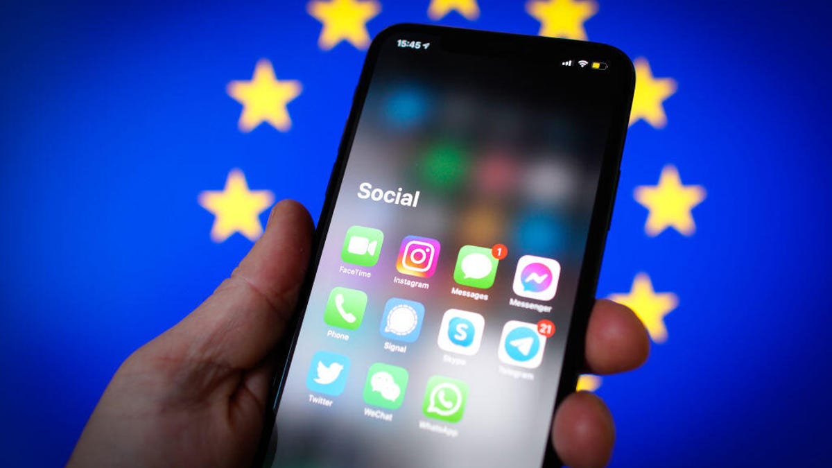Phone screen with social media logos on top of EU flag