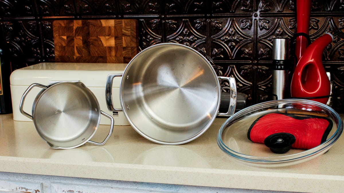 stainless steel pots sitting on a counter