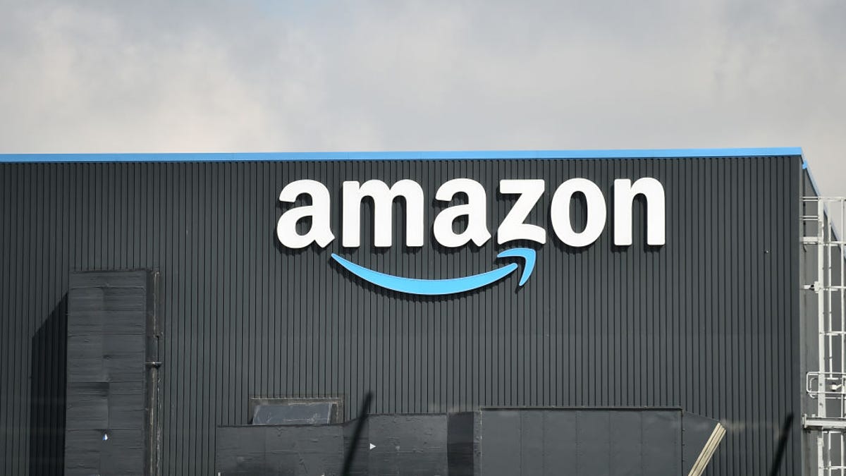 A warehouse with a large Amazon sign on the side.