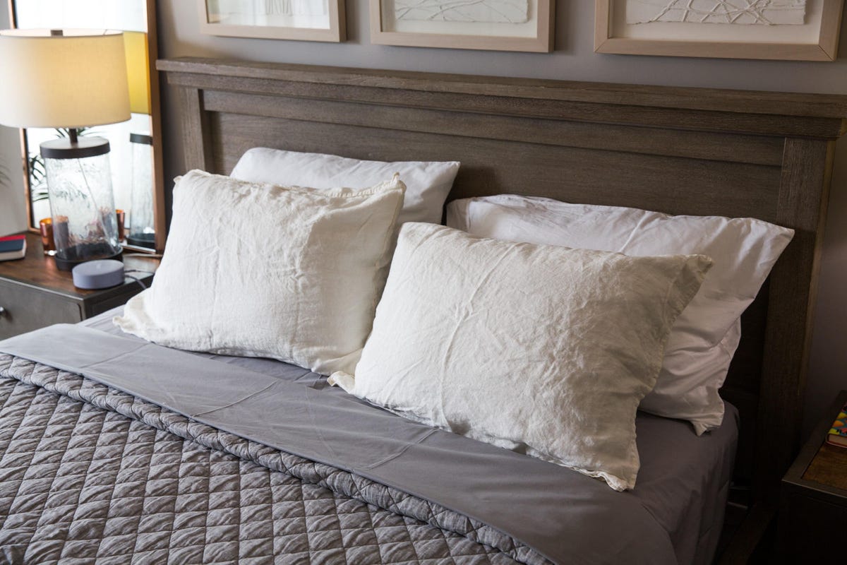 A bed with several white pillows