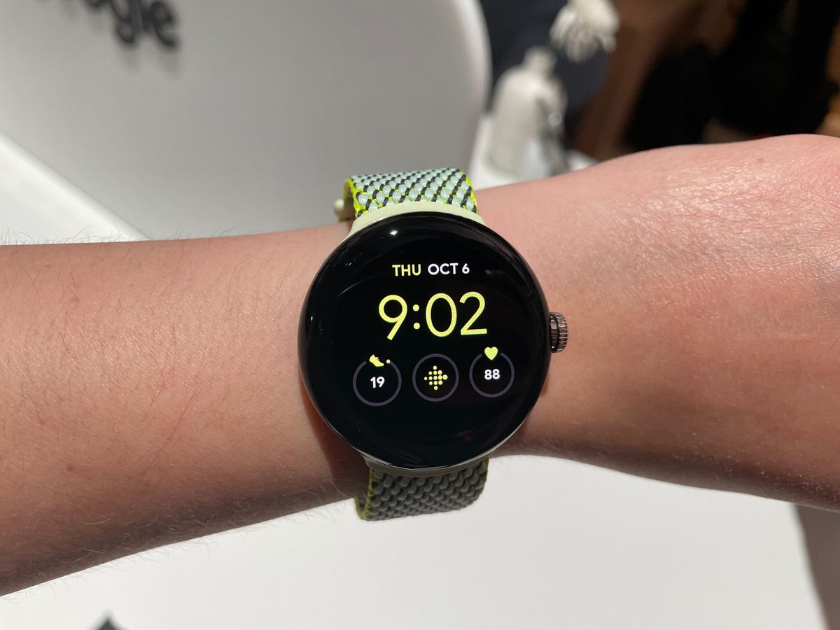Google Pixel Watch with a yellow watch face