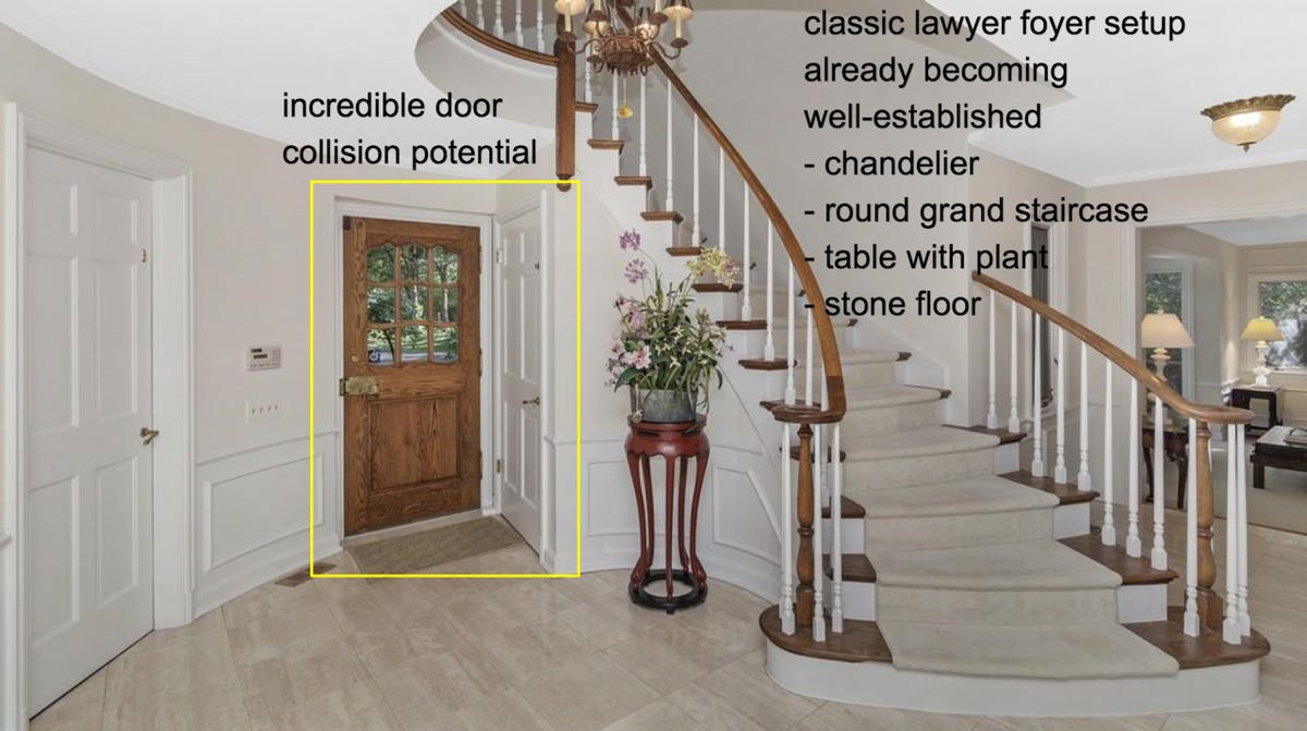 Foyer of a McMansion: "incredible door collision potential "classic lawyer foyer setup: chandelier, round grand staircase, table with plant, stone floor