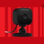 The Blink Mini compact indoor smart security camera is displayed against a red background.