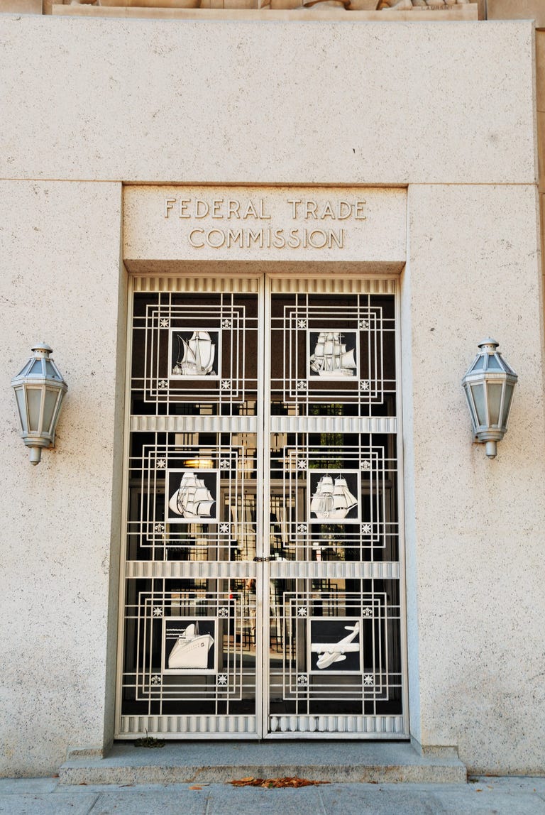 The door to the FTC, which features a metal gate with sculpted images of ships and an airplace.