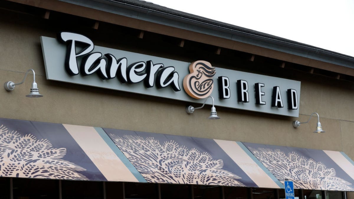 sign is posted on the exterior of a Panera Bread restaurant