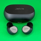 Jabra Elite 7 Pro earbuds and case on a green background
