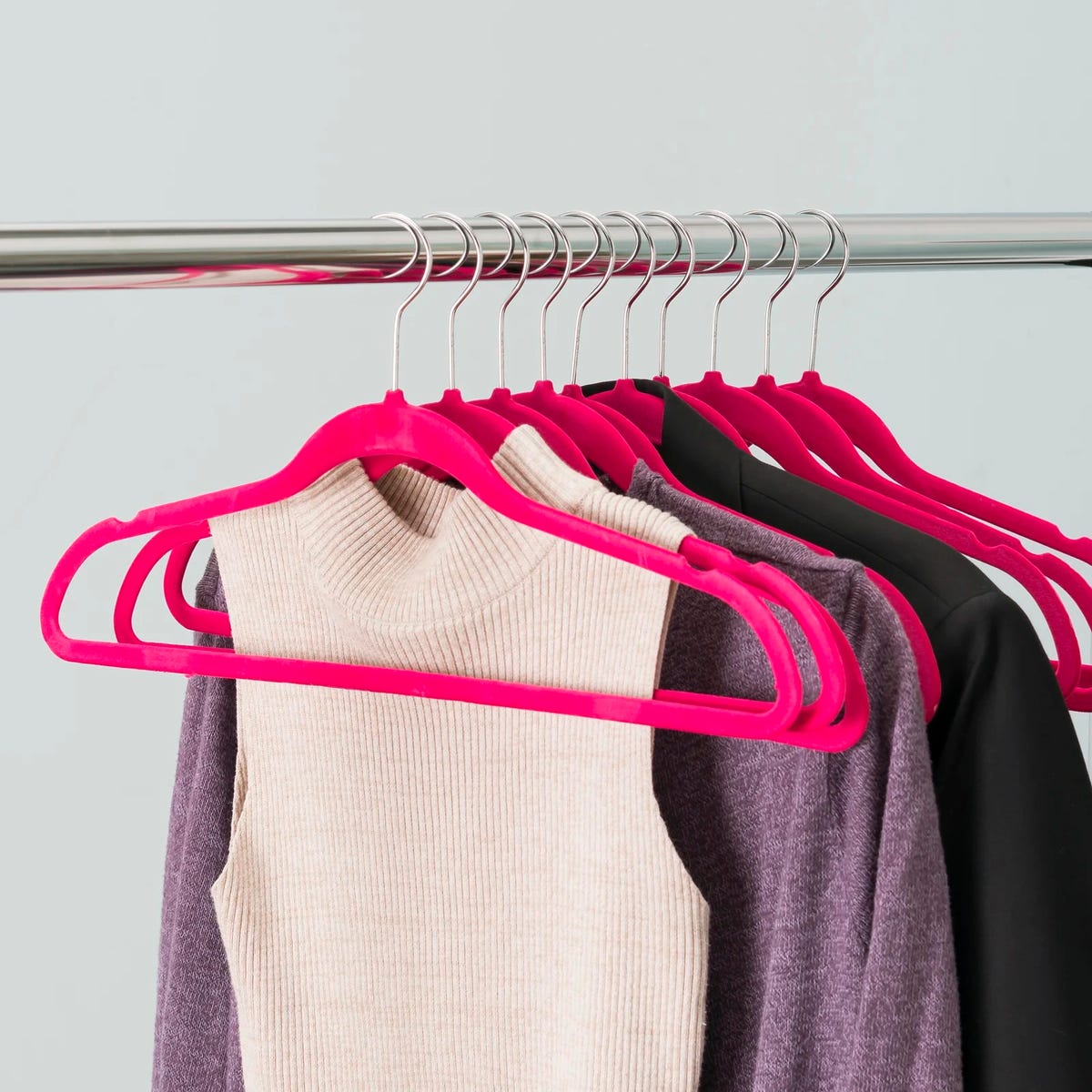 Clothes hanging on a pink plastic non-slip hanger