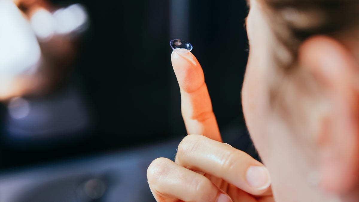 Close up of contact lens on a finger tip.