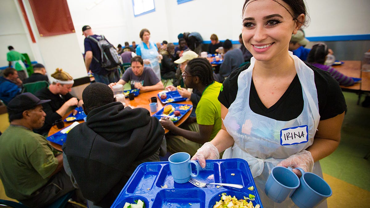 person serving food while volunteering