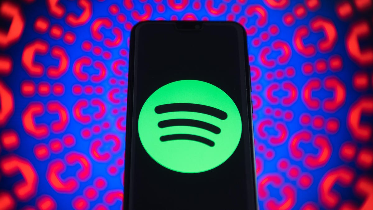Spotify logo is seen on a mobile phone