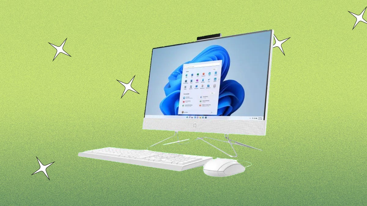 A white HP all-in-one desktop, keyboard and mouse against a green background.